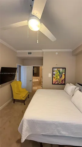 a bedroom with a bed and a television