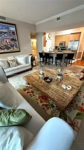 a living room with furniture and floor to ceiling window