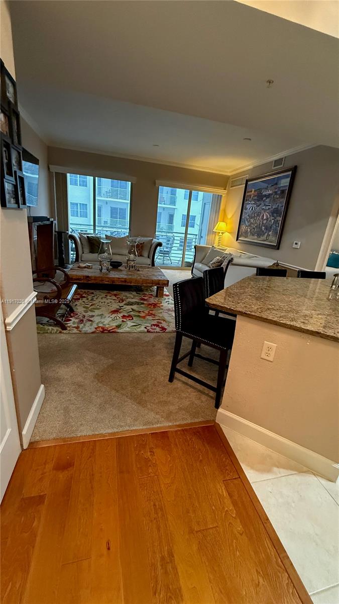 1830 Radius Drive, Unit 1105 Hollywood, FL 33020 - Photo 5 of 32 a living room with furniture and a open kitchen view