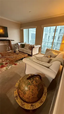 a living room with furniture and a floor to ceiling window
