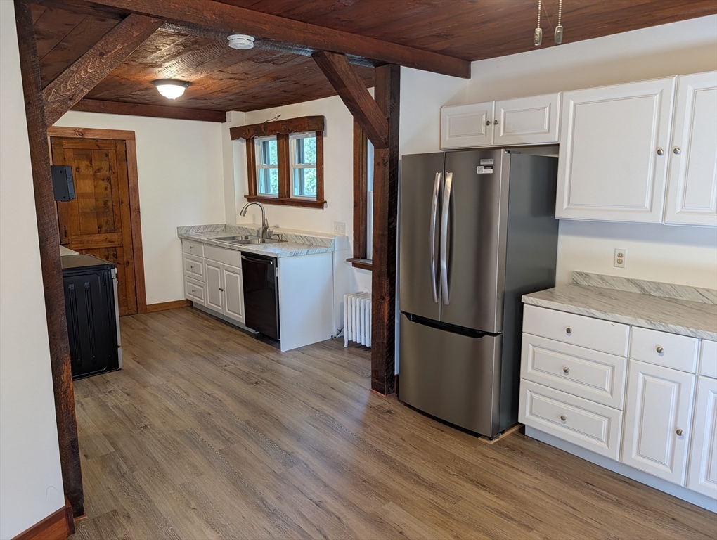 25 Graves Street Deerfield, MA 01373 - Photo 15 of 29 a kitchen with stainless steel appliances a refrigerator and wooden floor