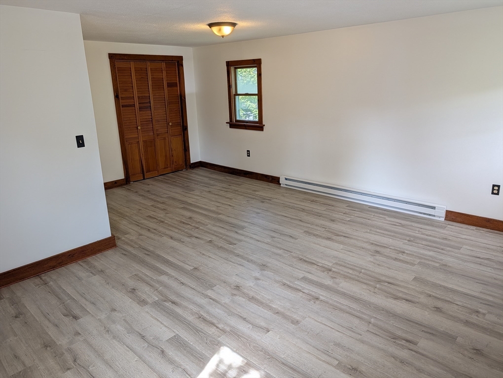 25 Graves Street Deerfield, MA 01373 - Photo 20 of 29 an empty room with wooden floor and windows