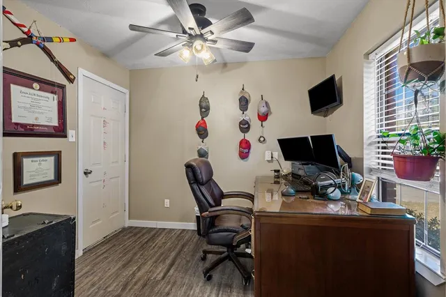 a view of a workspace with furniture and a flat screen tv