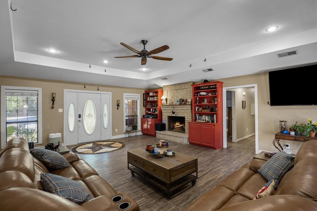 163 Granada Square Canton, TX 75103 - Photo 16 of 35 a living room with furniture and a flat screen tv