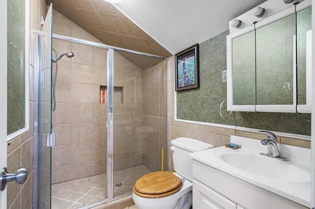 a bathroom with a sink toilet and shower