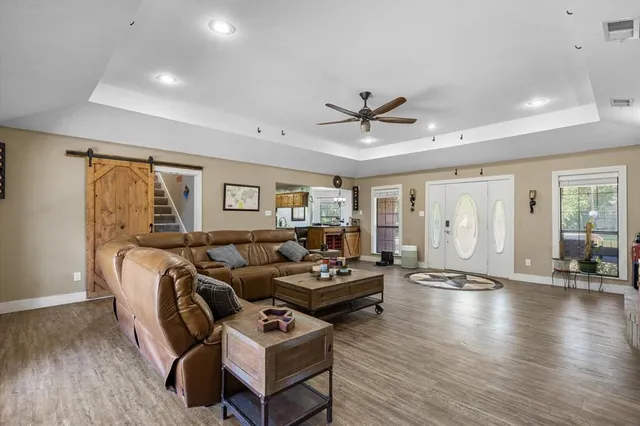 a living room with furniture and wooden floor