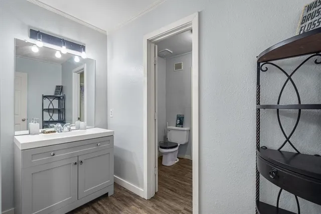 a en suite bathroom with a sink a toilet and mirror