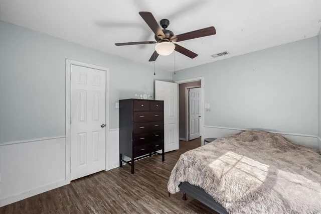 a bedroom with a bed and a ceiling fan