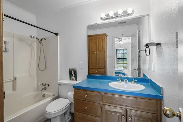 a bathroom with a sink toilet a shower and a mirror