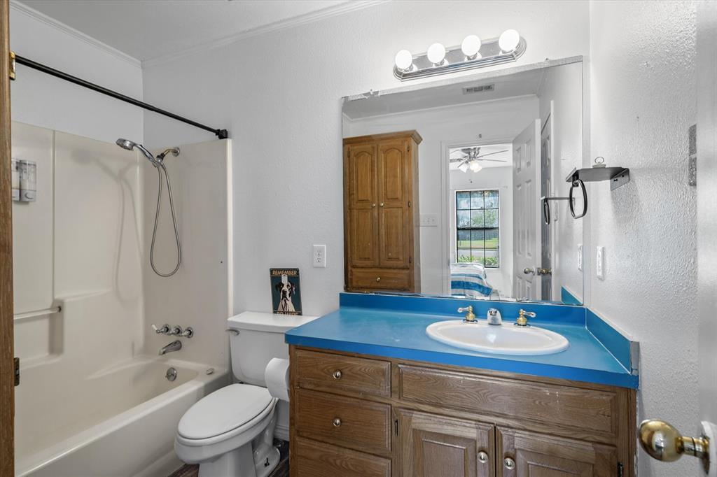 163 Granada Square Canton, TX 75103 - Photo 33 of 35 a bathroom with a sink toilet a shower and a mirror