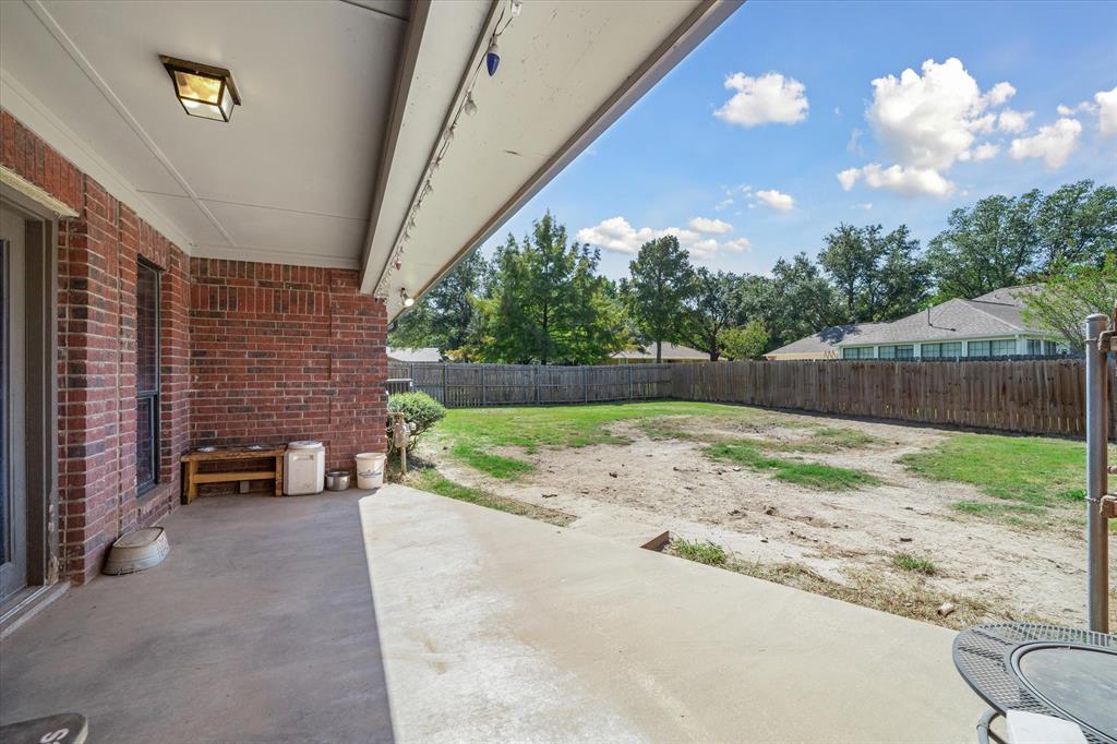 163 Granada Square Canton, TX 75103 - Photo 34 of 35 a backyard of a house with table and chairs