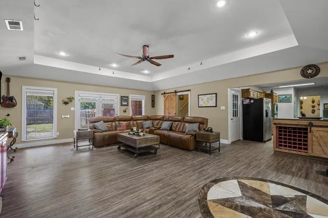 a living room with furniture and wooden floor