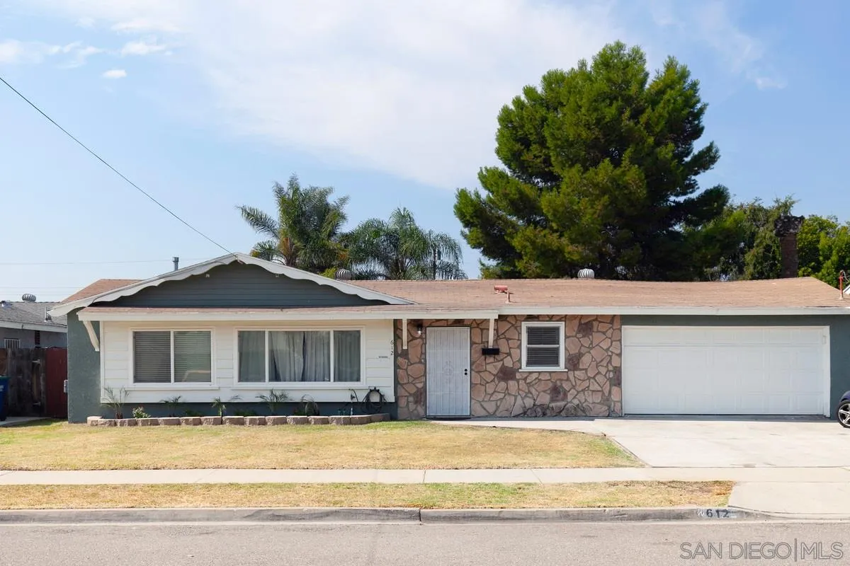 a front view of a house with a garden and yard