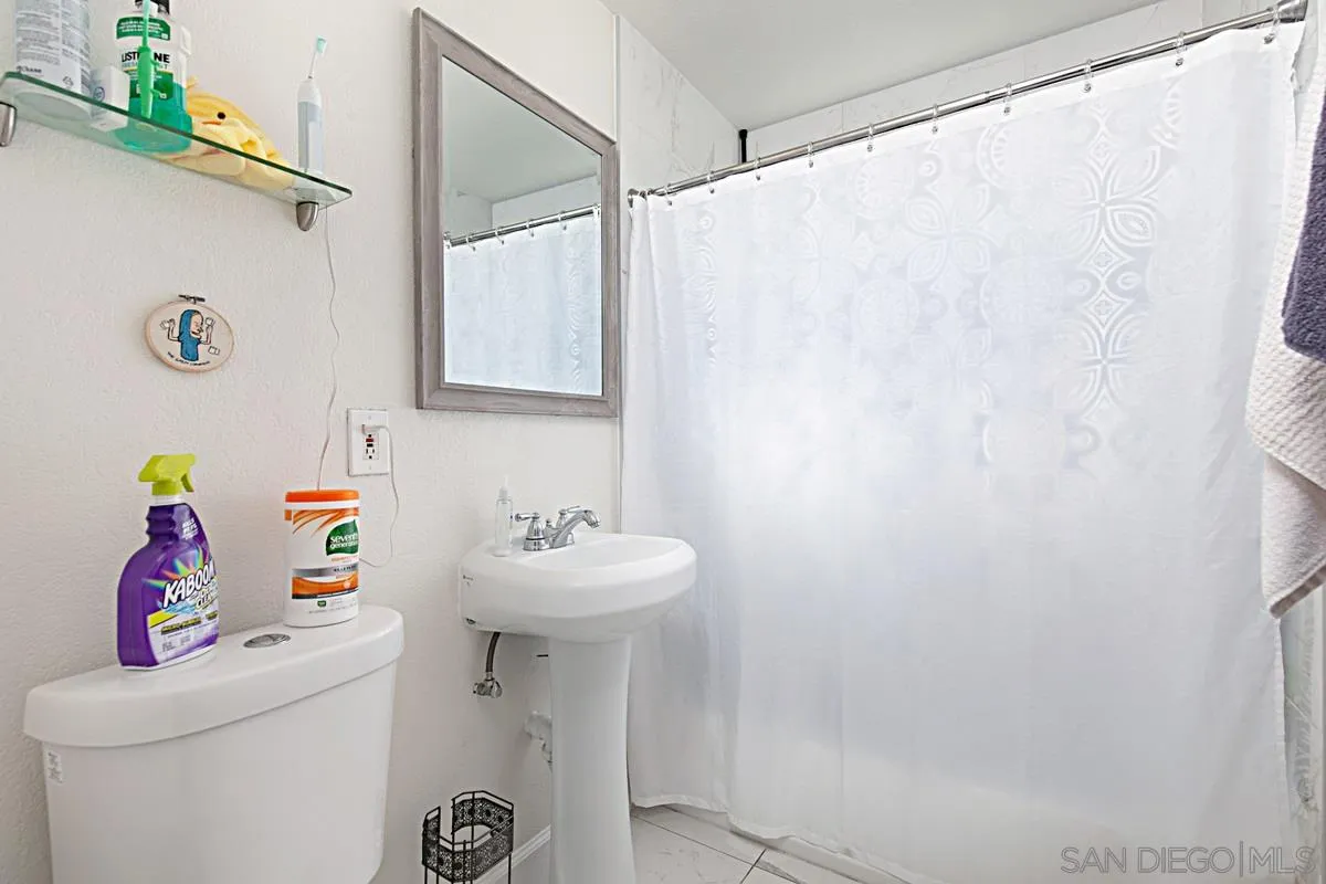 612 Broadview Street Spring Valley, CA 91977 - Photo 11 of 15 a bathroom with a sink a mirror and a toilet