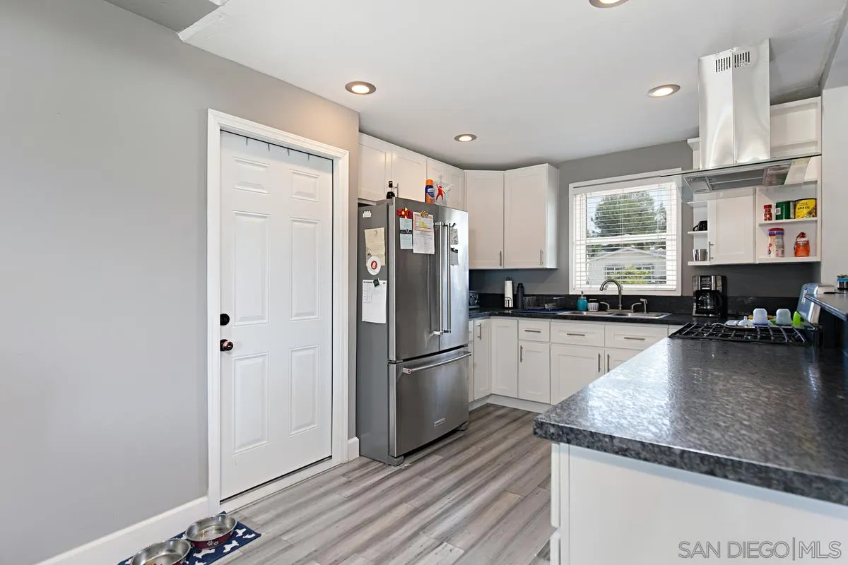612 Broadview Street Spring Valley, CA 91977 - Photo 3 of 15 a kitchen with a refrigerator and a sink