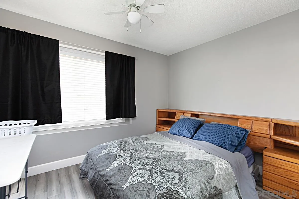 612 Broadview Street Spring Valley, CA 91977 - Photo 9 of 15 a bedroom with a bed and wooden floor