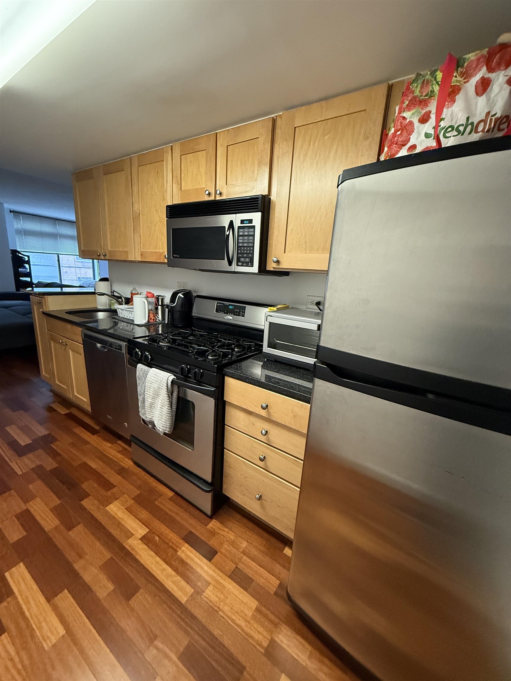 700 1st Street, Unit 2R Hoboken, NJ 07030 - Photo 3 of 13 a kitchen with stainless steel appliances granite countertop a stove a sink and a microwave