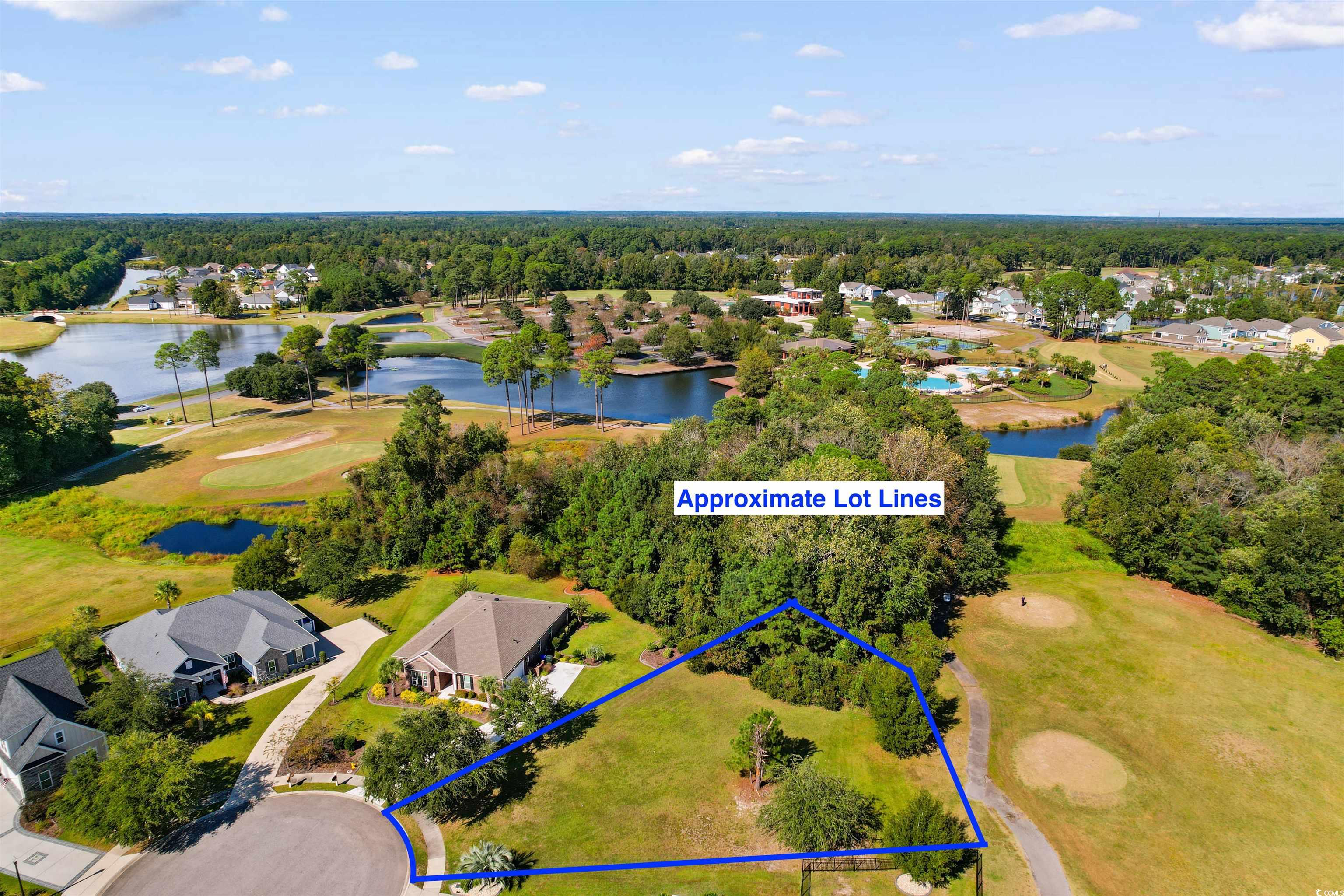 1005 Whooping Crane Drive Conway, SC 29526 - Photo 15 of 35 Aerial perspective of suburban area with a golf course, property parcel outlined, and a large body of water