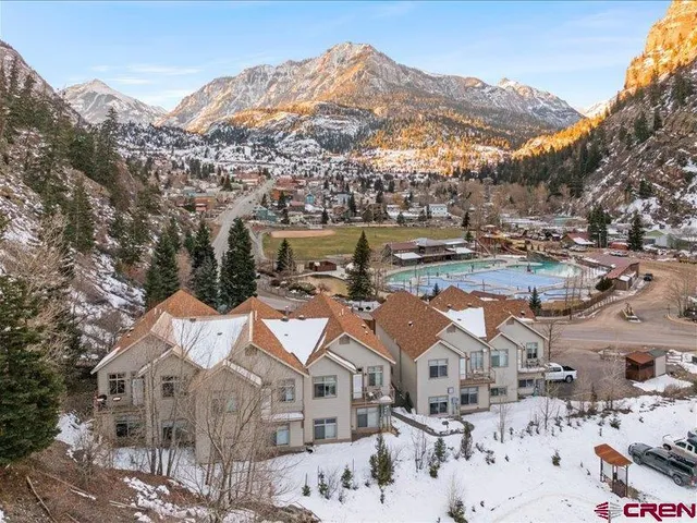 an aerial view of residential houses with outdoor space
