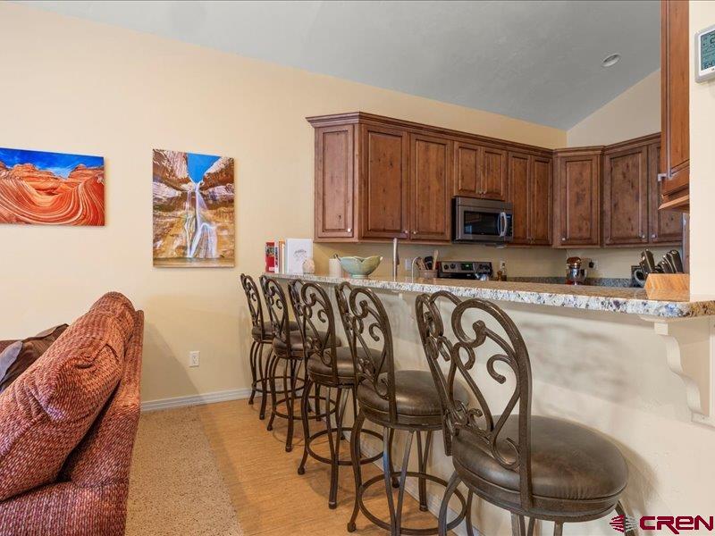 1271 Main Street Ouray, CO 81427 - Photo 13 of 45 a view of kitchen with stainless steel appliances granite countertop a stove a sink a table and chairs