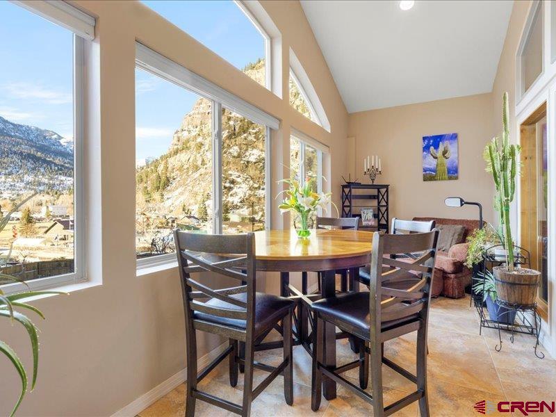 1271 Main Street Ouray, CO 81427 - Photo 19 of 45 a view of a dining room with furniture large windows and wooden floor
