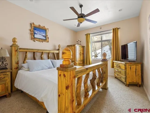 a bed room with a bed and a television