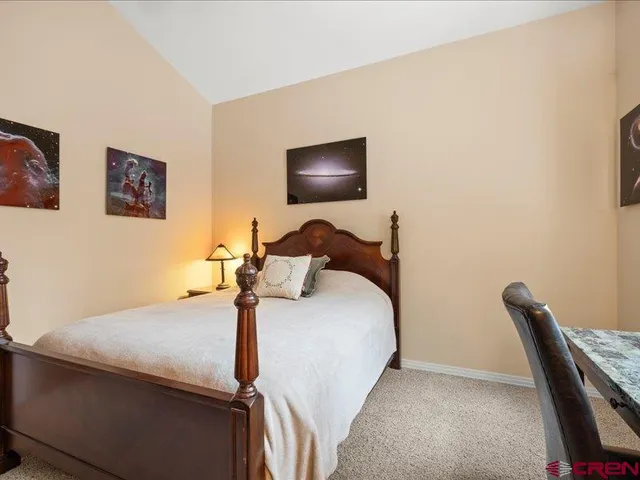 a bedroom with a bed and a chair