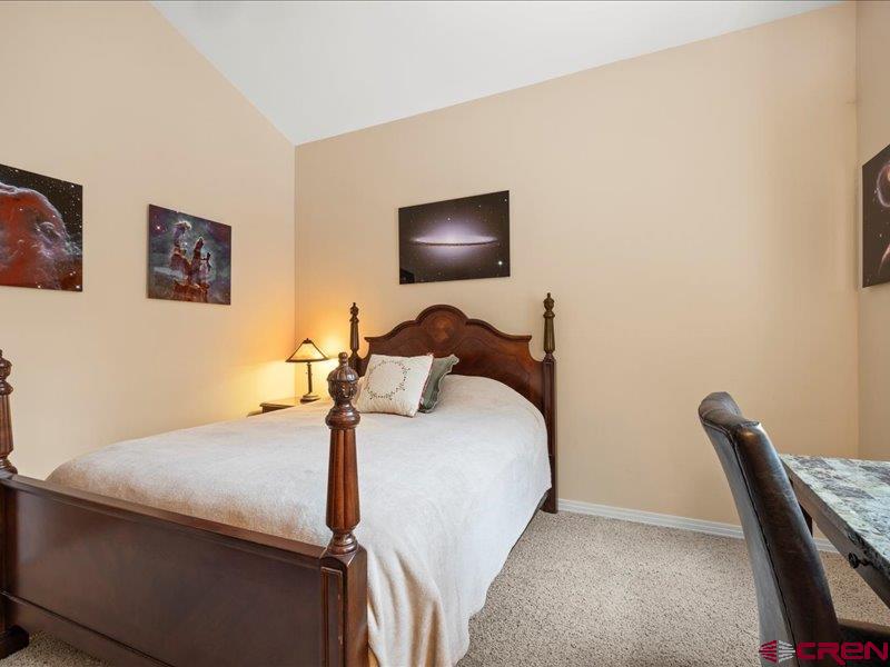 1271 Main Street Ouray, CO 81427 - Photo 27 of 45 a bedroom with a bed and a chair