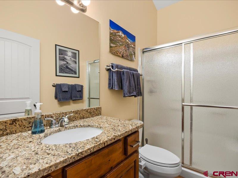 1271 Main Street Ouray, CO 81427 - Photo 34 of 45 a bathroom with a granite countertop sink toilet and shower