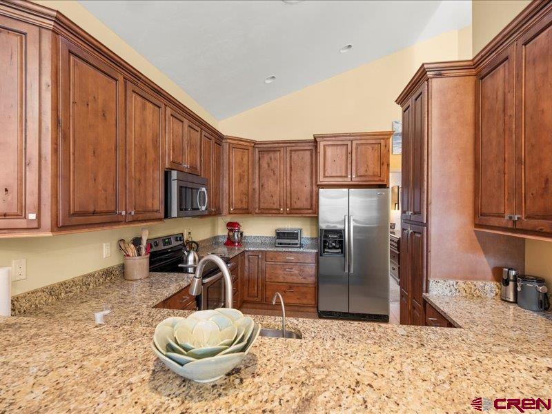 1271 Main Street Ouray, CO 81427 - Photo 9 of 45 a kitchen with a refrigerator a stove a sink and cabinets