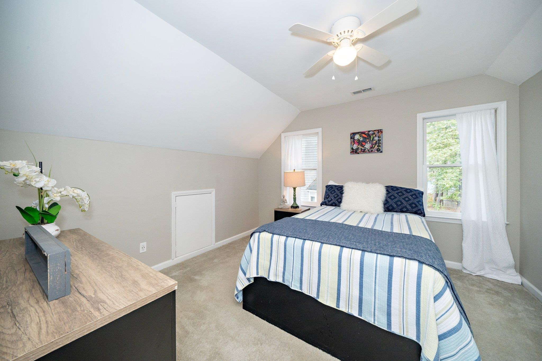 4400 Liverpool Lane Raleigh, NC 27604 - Photo 16 of 34 a bedroom with a bed and a chandelier