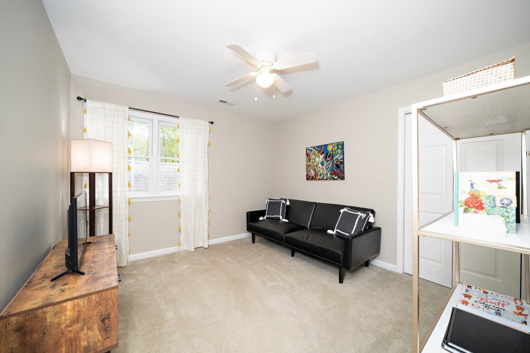 4400 Liverpool Lane Raleigh, NC 27604 - Photo 18 of 34 a living room with furniture and a flat screen tv
