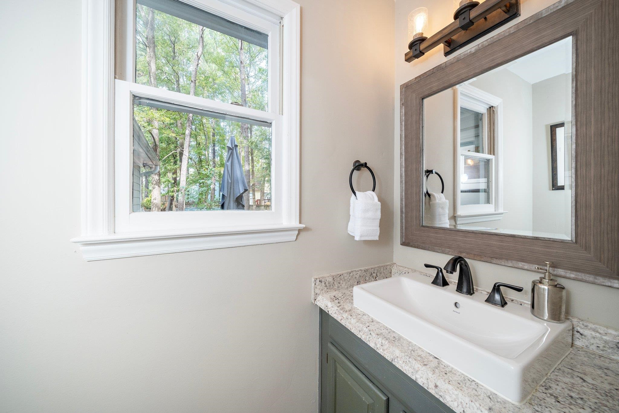 4400 Liverpool Lane Raleigh, NC 27604 - Photo 19 of 34 a bathroom with a sink and a mirror