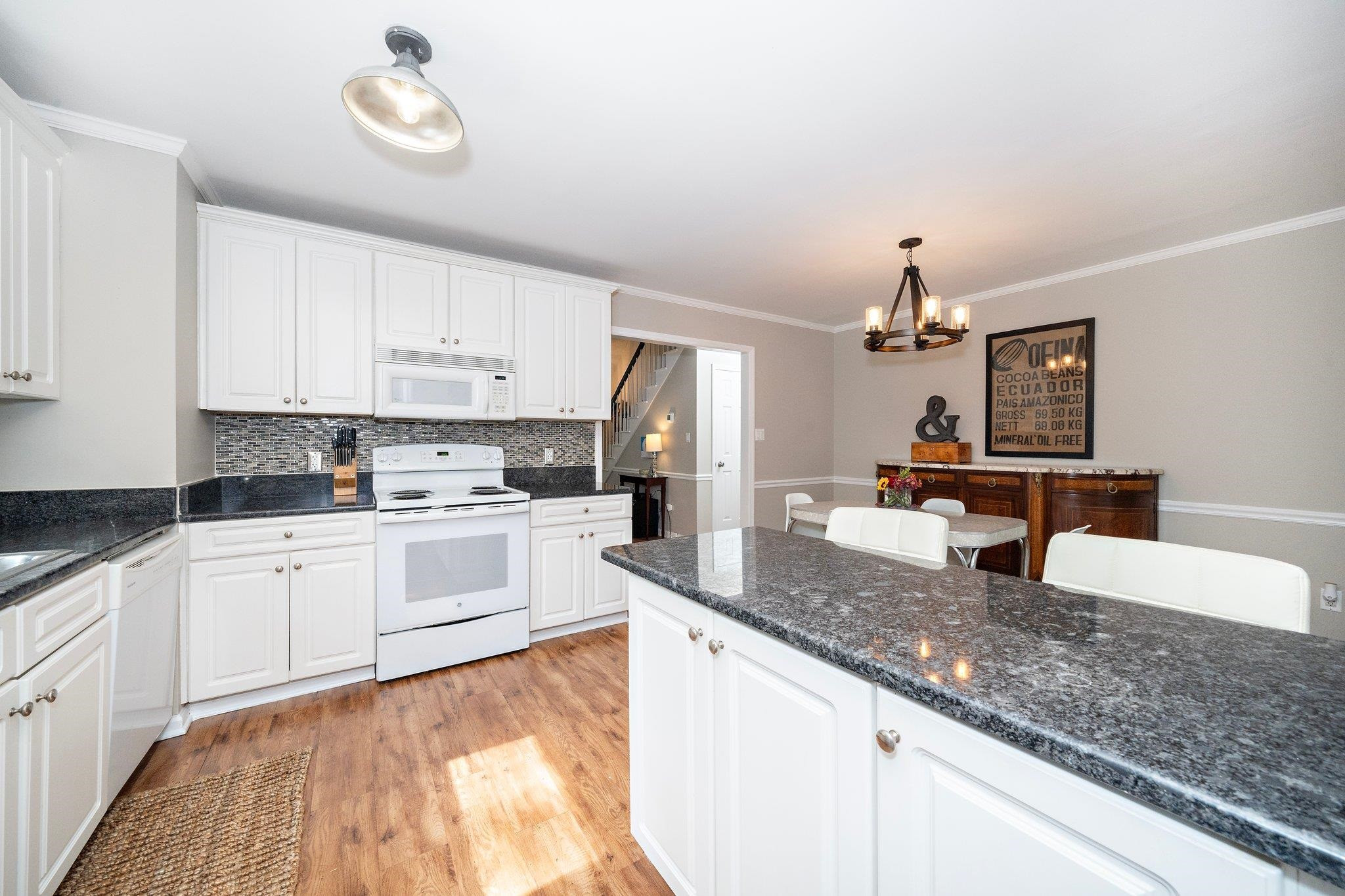 4400 Liverpool Lane Raleigh, NC 27604 - Photo 23 of 34 a kitchen with granite countertop stainless steel appliances a sink stove and cabinets