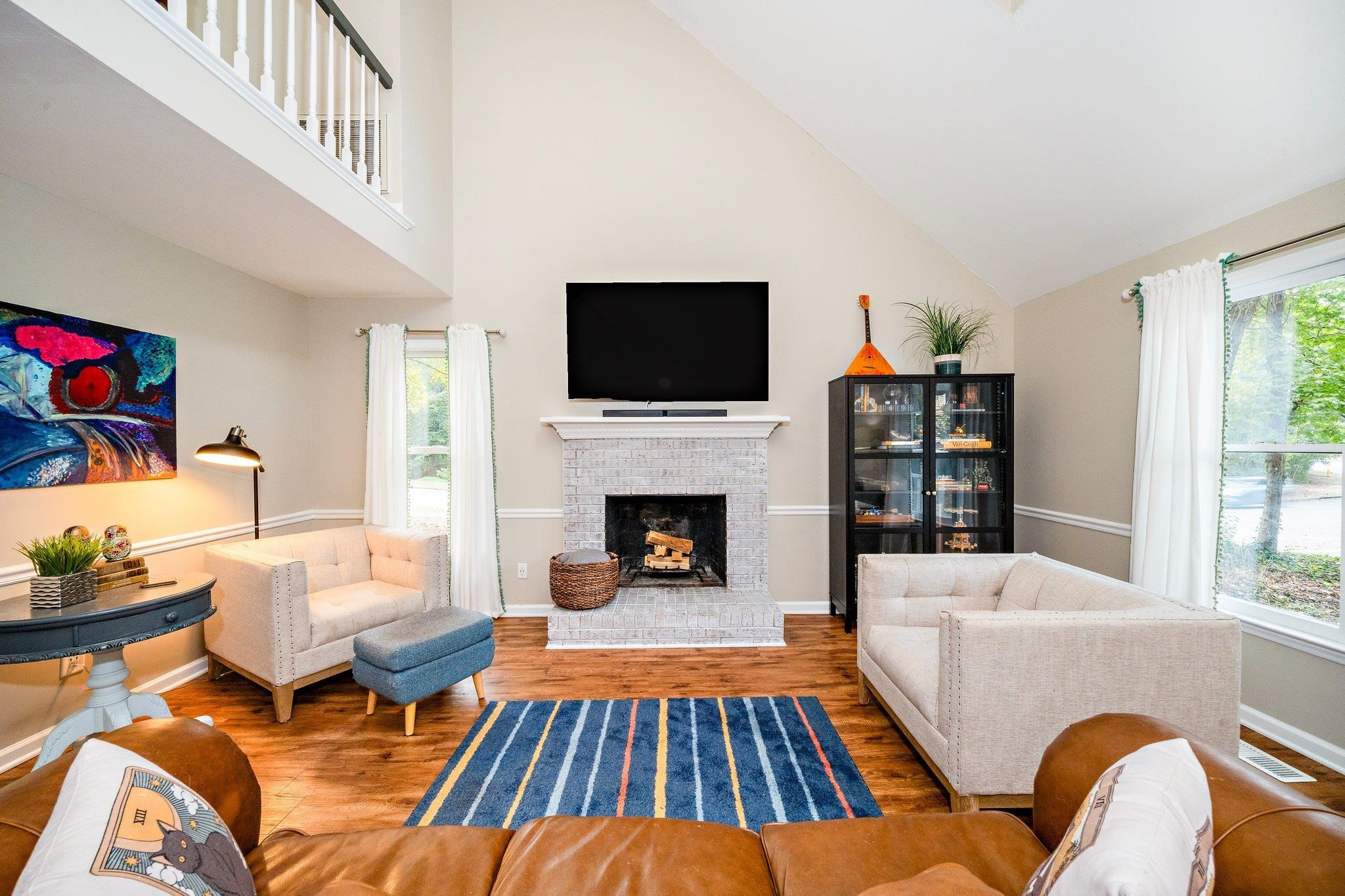 4400 Liverpool Lane Raleigh, NC 27604 - Photo 27 of 34 a living room with furniture fireplace and flat screen tv