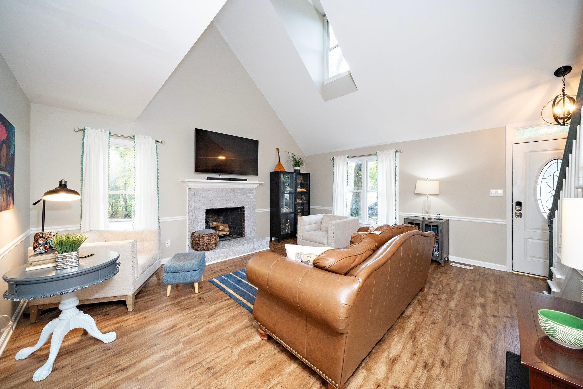 4400 Liverpool Lane Raleigh, NC 27604 - Photo 28 of 34 a living room with furniture a flat screen tv and a fireplace