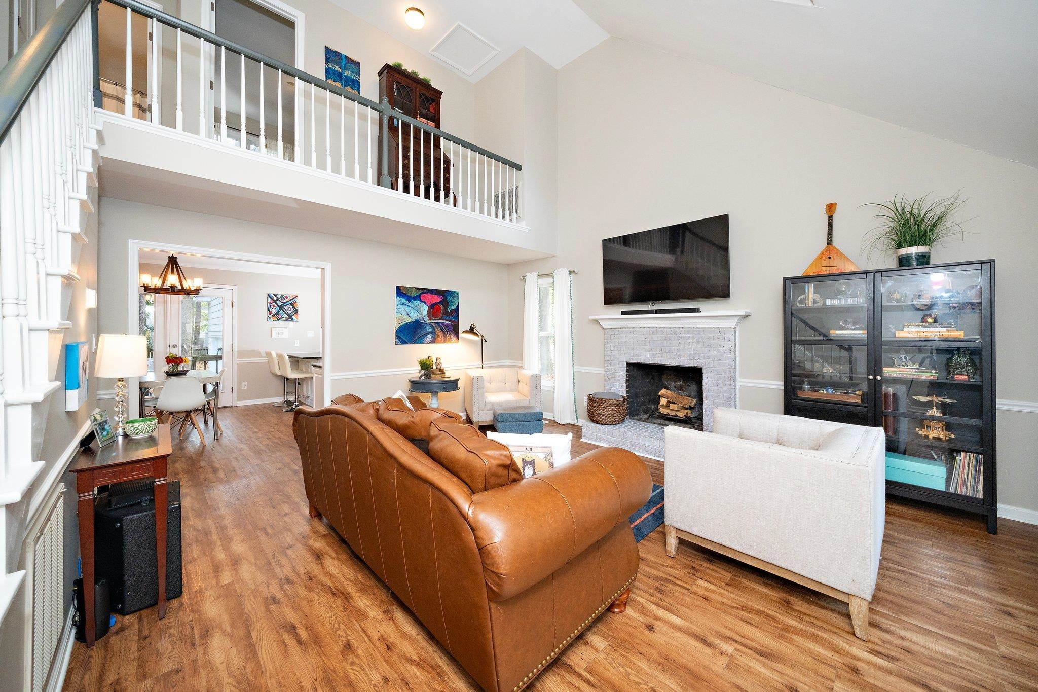 4400 Liverpool Lane Raleigh, NC 27604 - Photo 29 of 34 a living room with furniture a flat screen tv and a fireplace