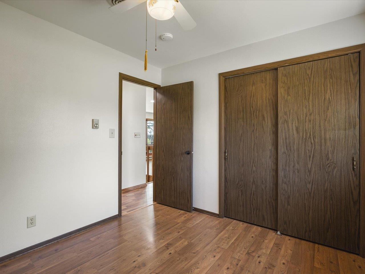 136 Lake Summerset Road Lake Summerset, IL 61019 - Photo 21 of 47 a view of an empty room with wooden floor and a ceiling fan