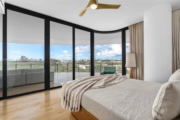 a bedroom with a bed and large window