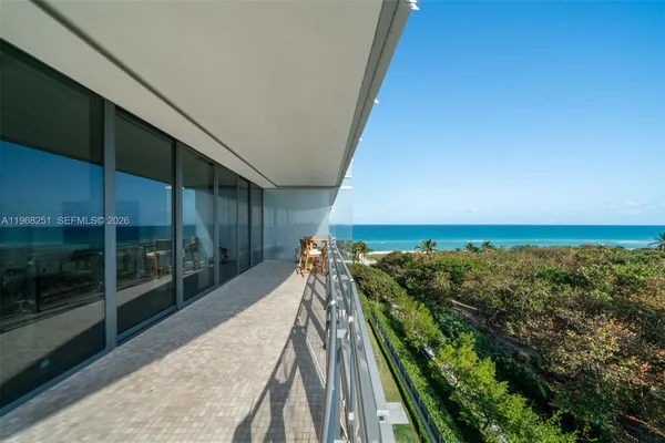 a view of a terrace with couches and sky view