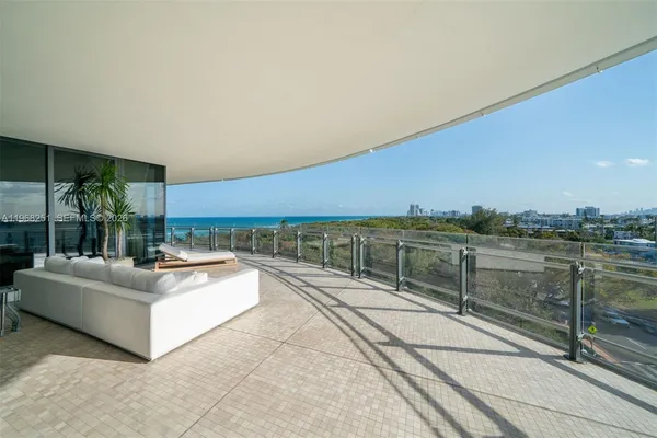 a terrace with outdoor seating and city view