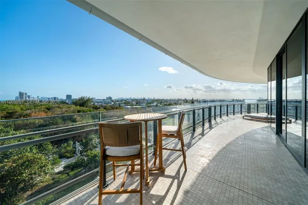 a view of a balcony with chair and wooden floor