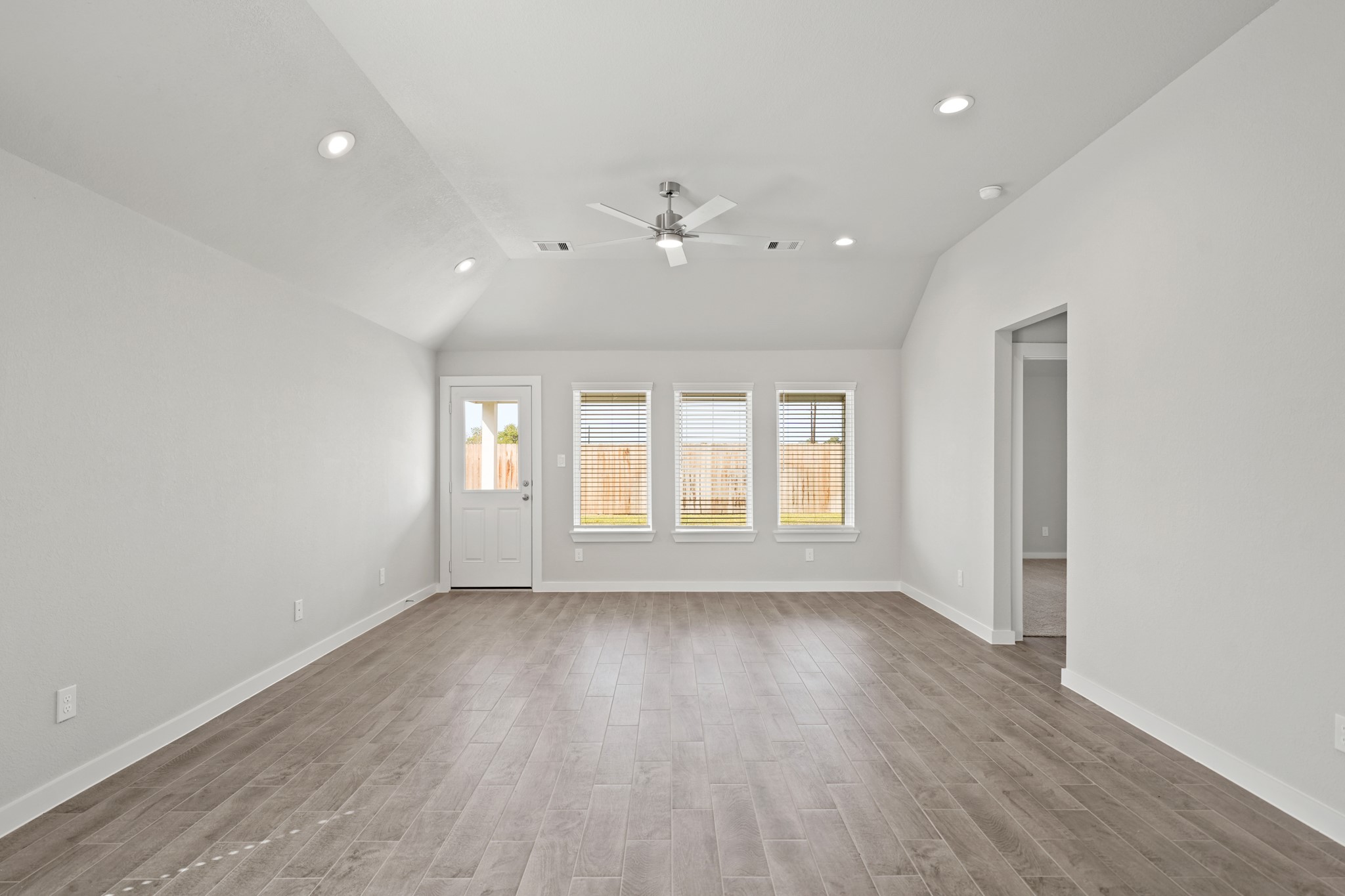 3106 Boulder Ridge Drive Rosenberg, TX 77471 - Photo 8 of 34 an empty room with wooden floor and windows