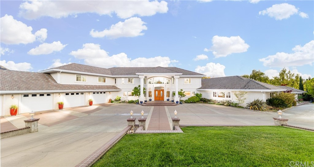 22595 Adobe Road Red Bluff, CA 96080 - Photo 3 of 71 a front view of a house with a yard and potted plants
