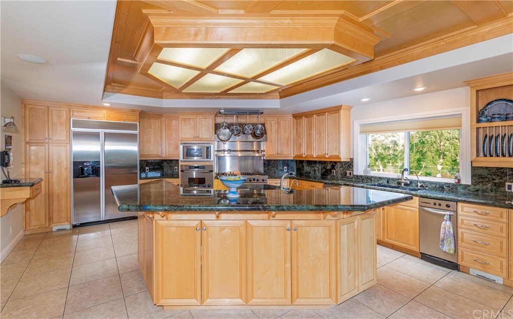 22595 Adobe Road Red Bluff, CA 96080 - Photo 36 of 71 a kitchen with stainless steel appliances granite countertop a sink and cabinets