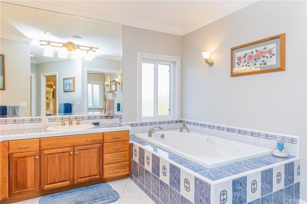 22595 Adobe Road Red Bluff, CA 96080 - Photo 57 of 71 a spacious bathroom with a tub double vanity sink and a mirror