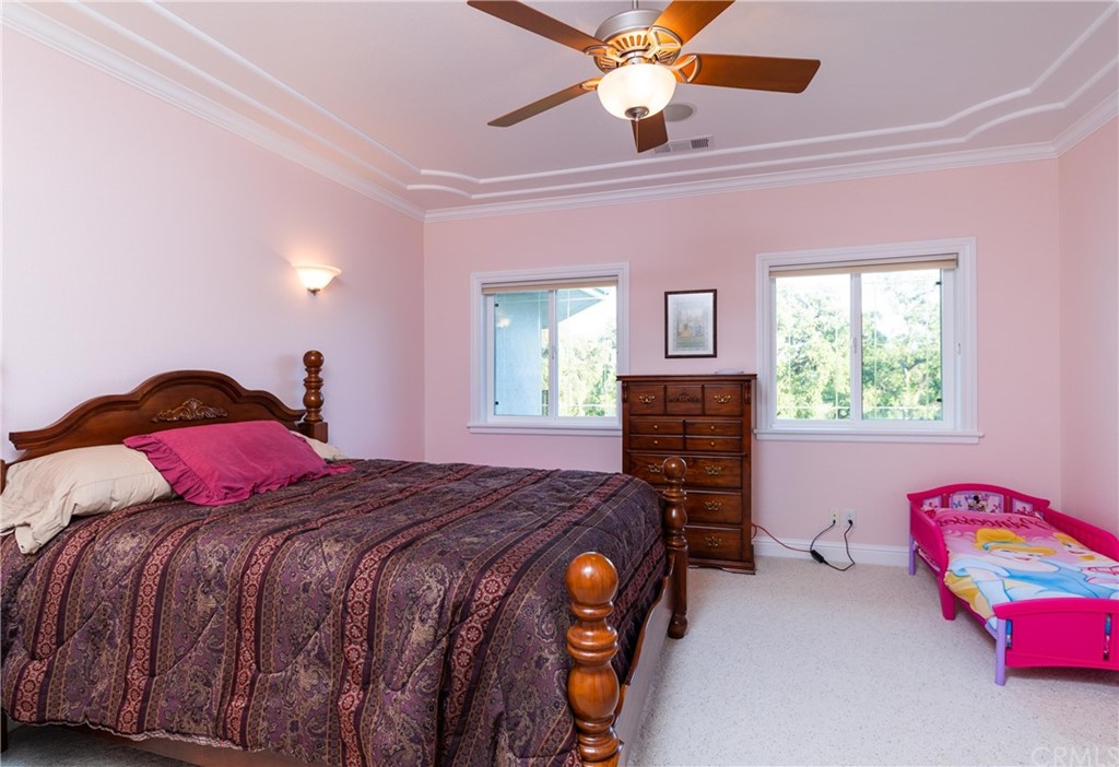 22595 Adobe Road Red Bluff, CA 96080 - Photo 62 of 71 a bedroom with a bed and a chandelier