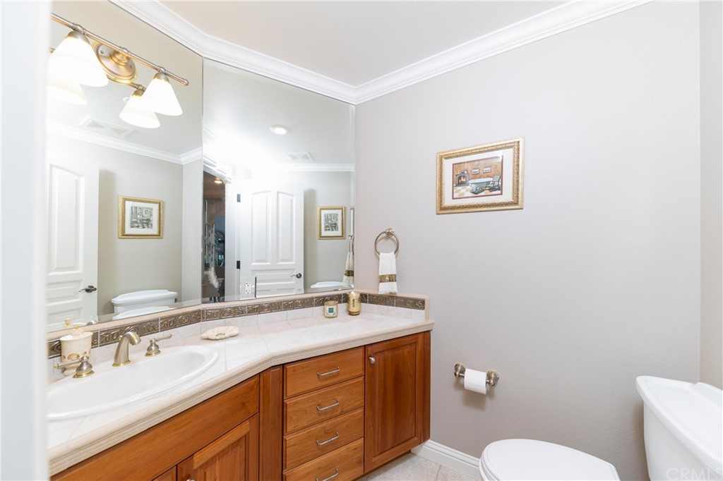 22595 Adobe Road Red Bluff, CA 96080 - Photo 63 of 71 a bathroom with a double vanity sink mirror and toilet