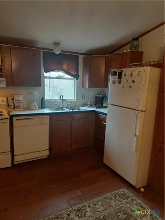 a white refrigerator freezer sitting inside of a kitchen