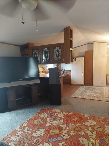 a kitchen with refrigerator and table